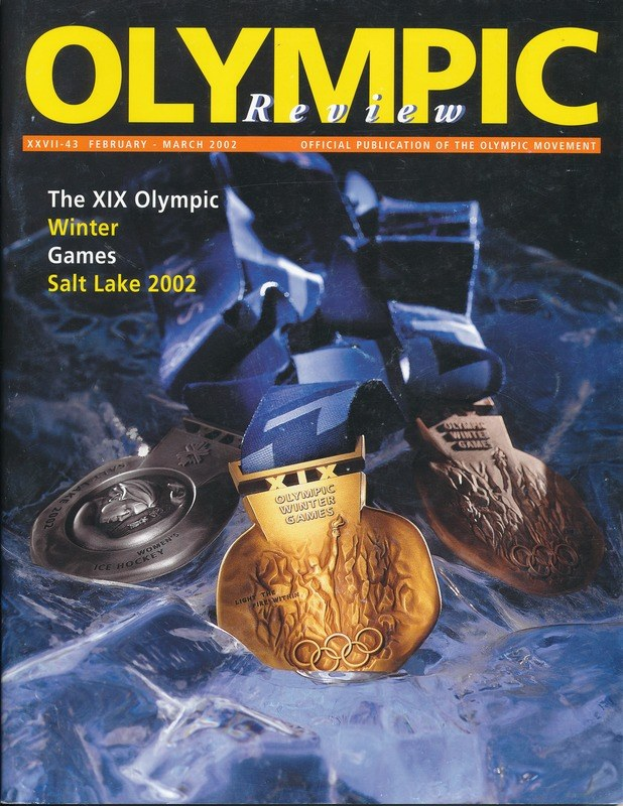 Buch mit dem Titel "Olympische Übersichtszeitschrift" mit mehreren Medaillen in verschiedenen Größen und Farben und fetter Schrift auf dem Cover.