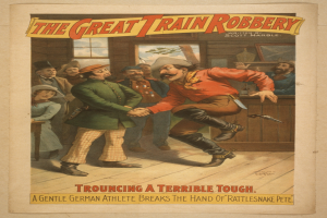 Ein Plakat zeigt eine Gruppe von Menschen auf einem Boden, einer hält eine Waffe, mit Text oben und unten 'The Great Train Robbery - Trouching a Terrible Tough'.
